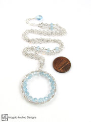The Infinity Circle Hammered Silver Necklace With Blue Topaz Gemstones